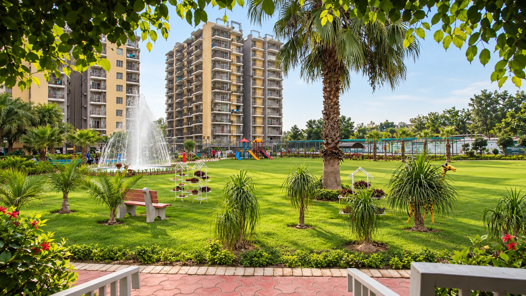 Landscaped lawn with fountain and residential towers at Trishla City
